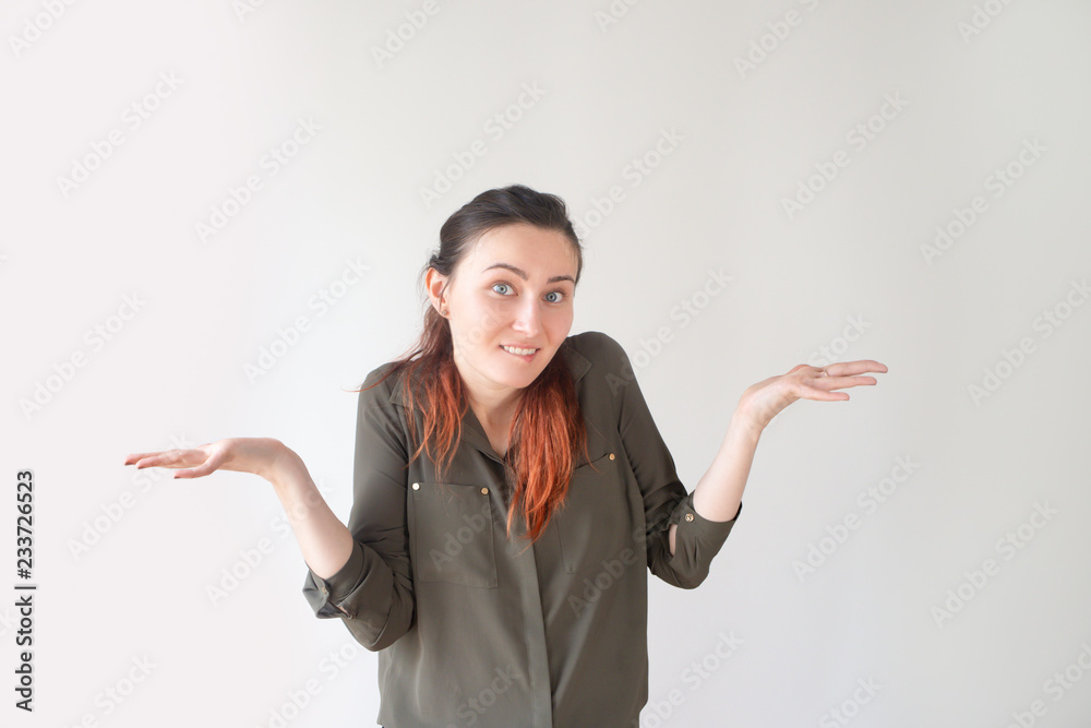 Pretty Caucasian girl biting lip and spreading hands. Young female student in casual shirt having no explanation. Forgotten homework concept Pretty Caucasian girl biting lip and spreading hands. Young female student in casual shirt having no explanation. Forgotten homework concept