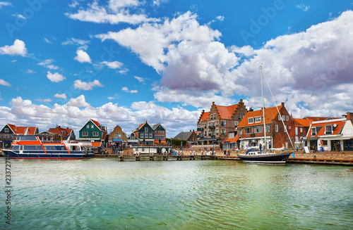 Volendam, Netherlands. High-speed motorboat by docks near old photo