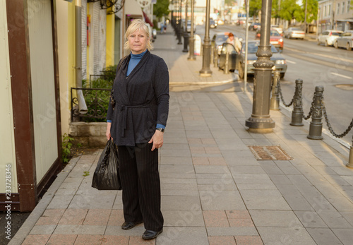 Portrait of beautiful aged woman in the street.