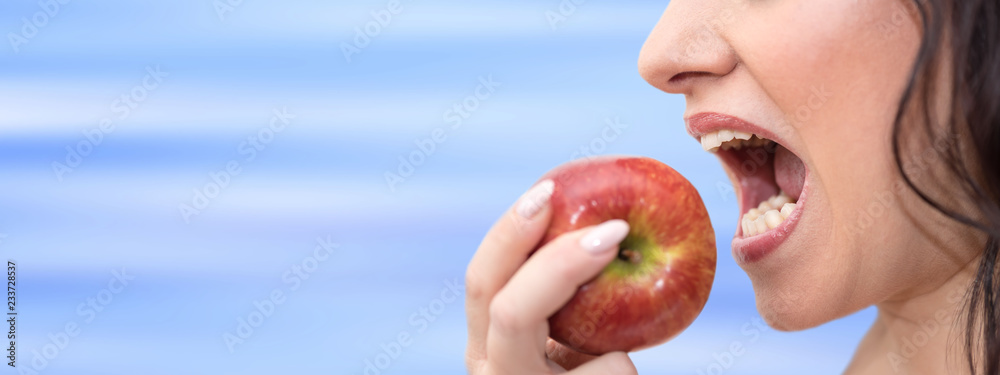 Woman biting an apple