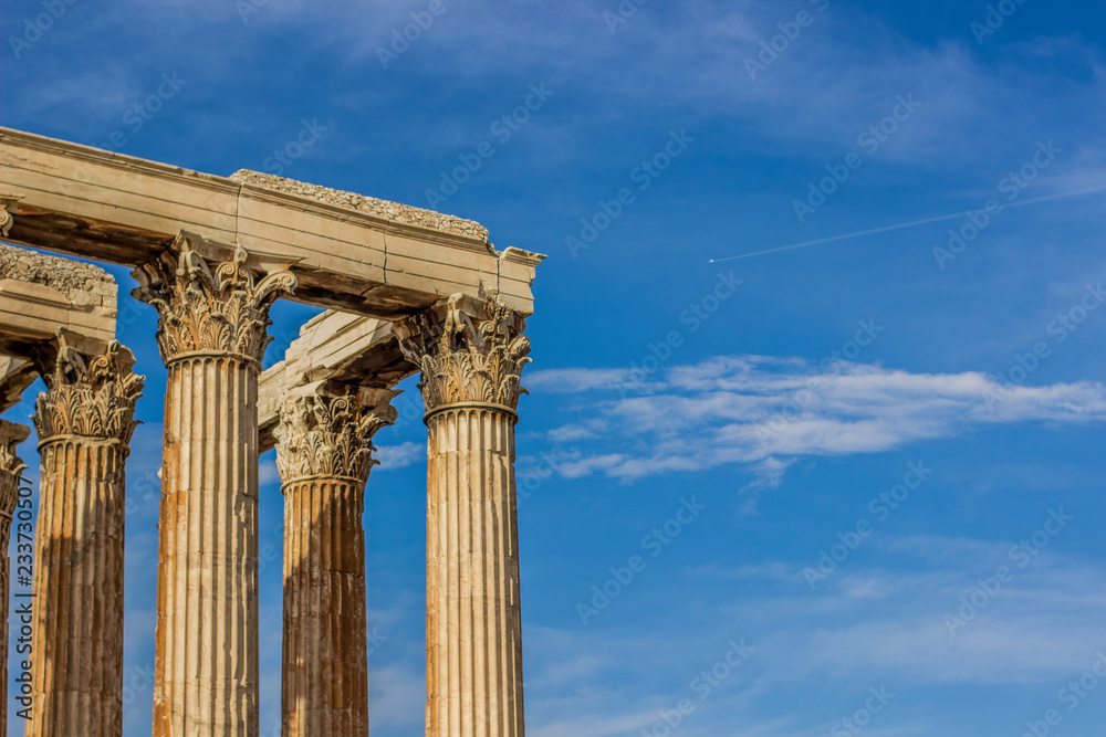 marble columns shape in golden yellow color from evening sunset sun light on blue sky background with empty space for copy or text