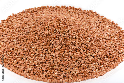 Pile of buckwheat isolated on white plate