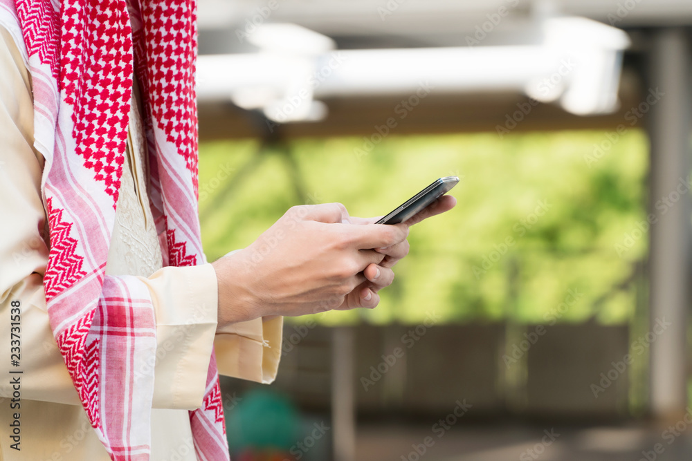 Hand of Arab Middle Eastern young businessman using smartphones. Technology concept.