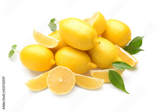 Pile of fresh whole and cut lemons on white background