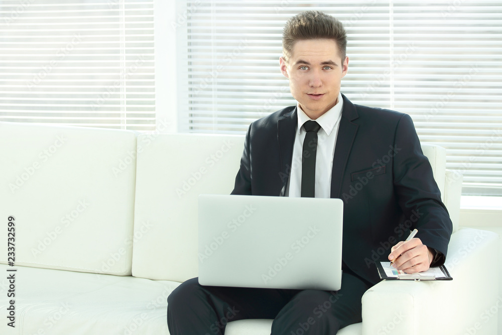 confident businessman working on laptop sitting in the spacious confident businessman working on laptop sitting in the spacious