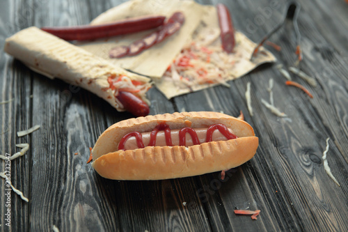 hot dogs and fast food dishes on wooden background