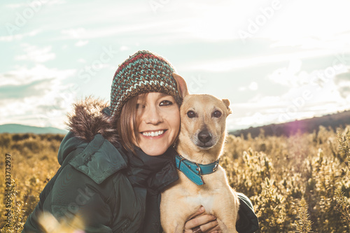 Portrait of a dog and a young woman in the country .Concept of love between dog and person