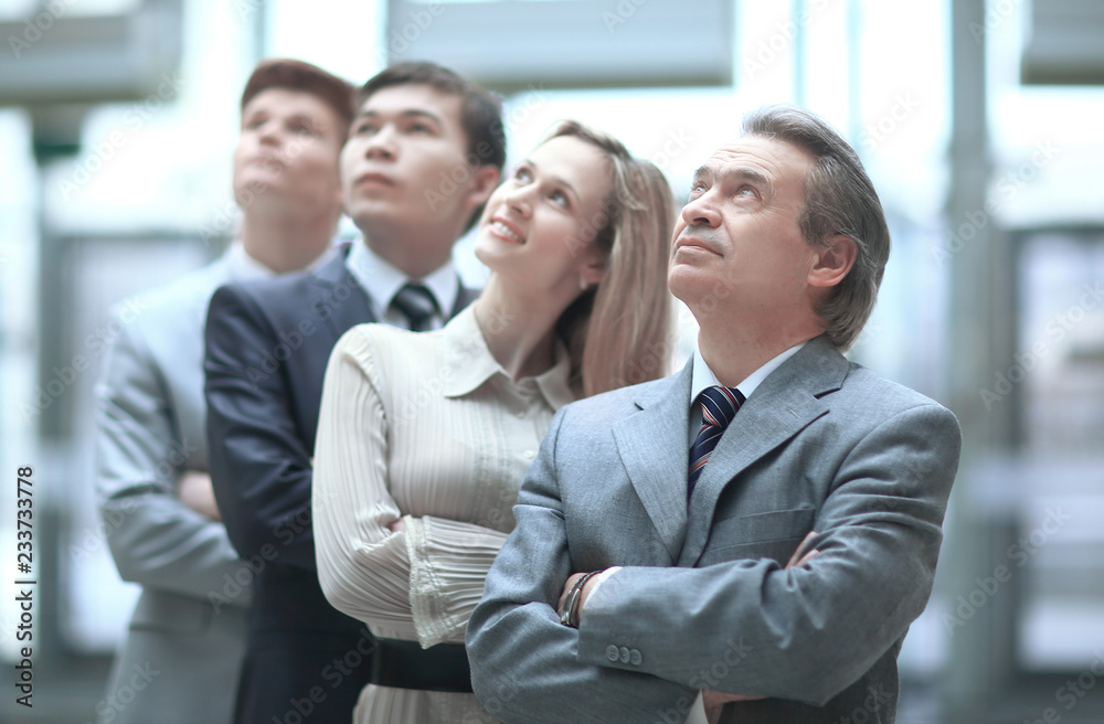 smiling business team looking up at copy space