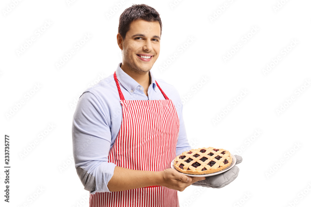 Handsome man with apron holding a cherry pie Handsome man with apron holding a cherry pie