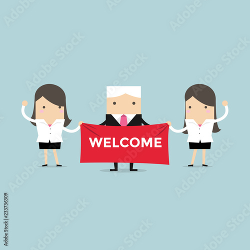Businesswoman and boss holding welcome sign.