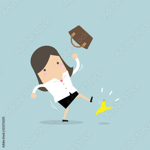 Businesswoman slipping on a banana peel and falling down.