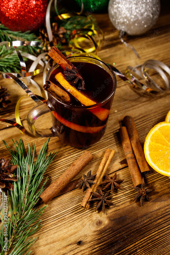 Christmas mulled wine with spices and Christmas decoration on wooden table