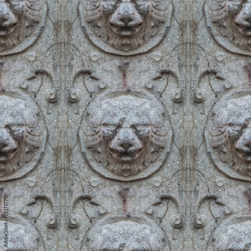 Seamless photo texture of antique stone lion head from broken castle wall