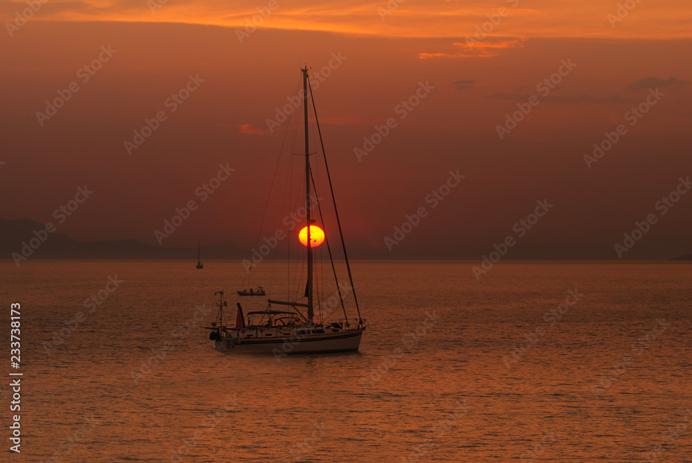 Traditional boat at sunset in Corfu island, Greece Traditional boat at sunset in Corfu island, Greece
