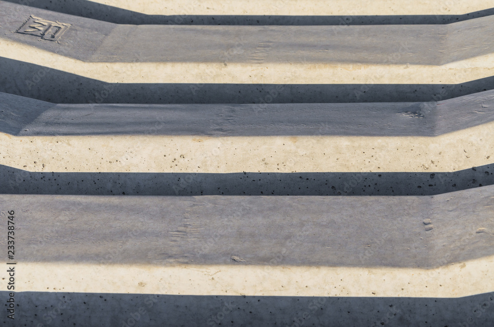 Fototapeta premium Stack of concrete railway sleepers in color image.