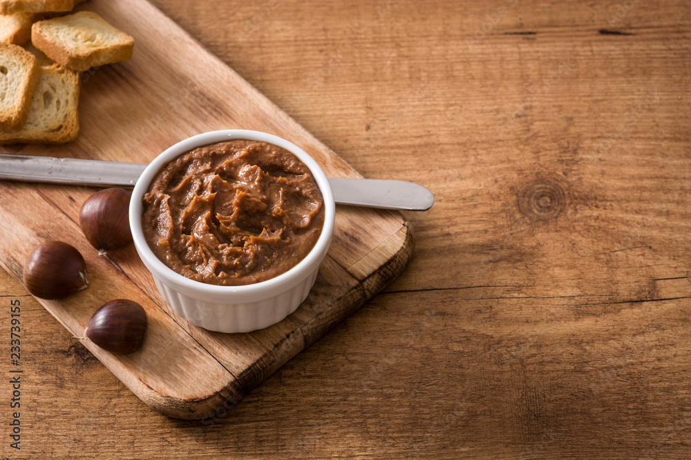 Chestnut cream on bowl wooden table. Copyspace