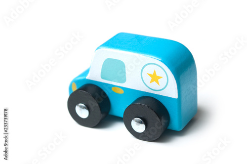 closeup of blue miniature wooden car on white background - concept police patrol
