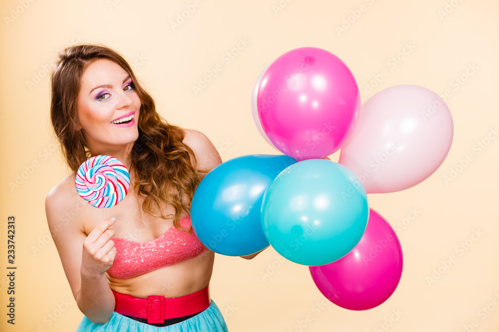 Woman holds lollipop candy and balloons Woman holds lollipop candy and balloons