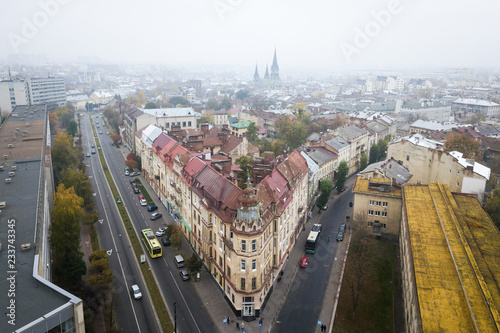 Aerial view of the corner house on the background of the Church of Olha and Elizabeth in Lviv, Ukraine