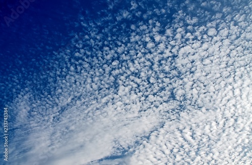 Alto cumulus clouds on a blue summy sky photo