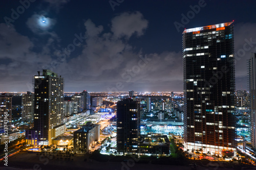 Moon over city with highrise buildings drone photography