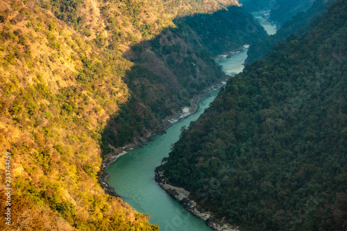 Spectacular view of the sacred Ganges river flowing through the green mountains of Rishikesh  Uttarakhand  India.