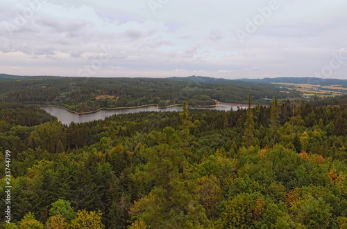 Aerial view to the Landstejn Water Reservoir in the forest. Scenic view from the tower of the Landstejn castle. Cloudy summer day