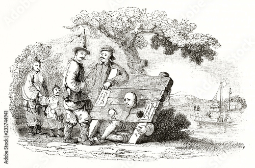 Old illustration of a man suffering the chinese pillory under the view of other people, outdoor. By unidentified author published on Magasin Pittoresque Paris 1839 photo