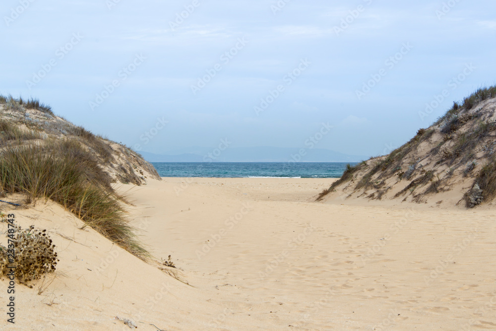 Sandy beach at Trafalgar in spain overlooking the sea and the waves Sandy beach at Trafalgar in spain overlooking the sea and the waves