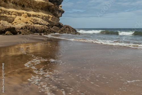 Canyon on Namibe Desert Beach. with sea waves. Angola. Africa. Namibe photo