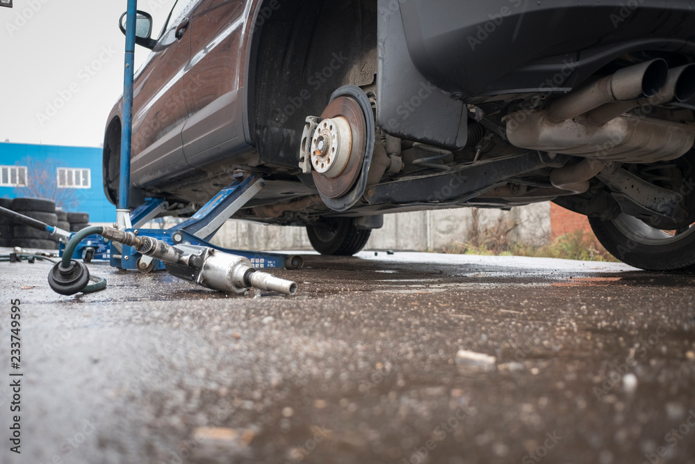 The car is lifted on jacks without wheels. Repair, tire installation. The car is lifted on jacks without wheels. Repair, tire installation.