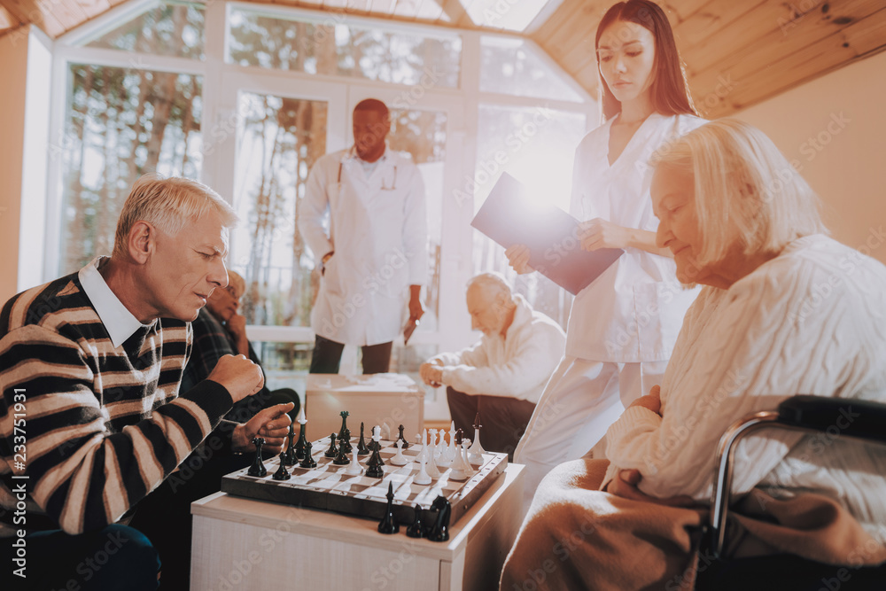 © Vadym Huzhva - Senior Woman and Man Play Chess. Nursing Home.