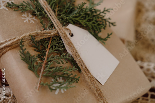 Blank Gift tag on Classy vintage Christmas gift box. Christmas presents with handmade decoration. Close up. Mockup. Copy space.