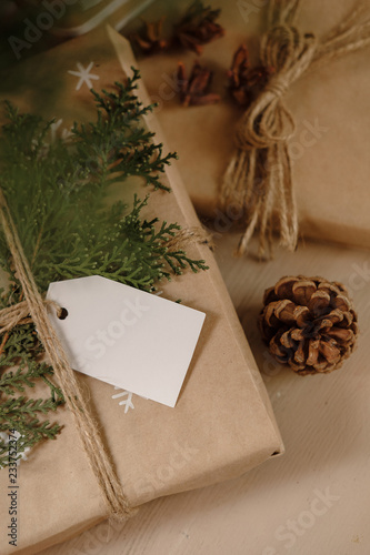 Blank Gift tag on Classy vintage Christmas gift box. Christmas presents with handmade decoration. Close up. Mockup. Copy space.