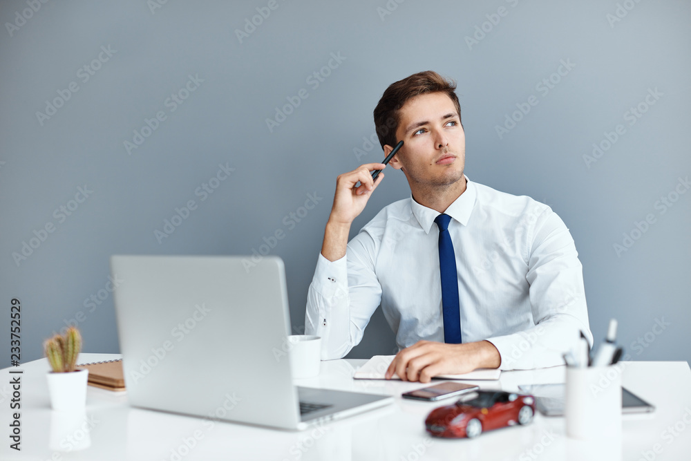 Young successful businessman on his work place Young successful businessman on his work place