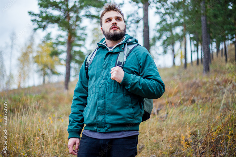 handsome male tourist hiking in the forest handsome male tourist hiking in the forest