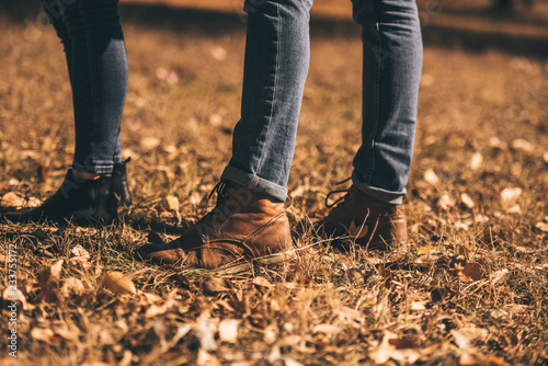 Boy and a girl in jeans in the park