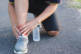 The man fill ankle or calf pain when he running exercise in a day time for sport,  ้health concept.