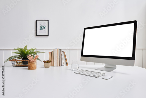Desktop screen detail white table and book in the office.