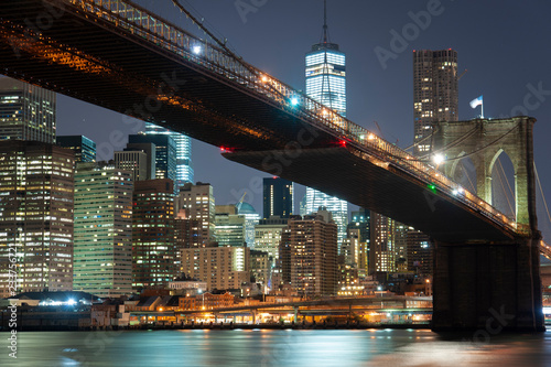 Lower Manhattan with Brooklyn bridge from across the Hudson river at night