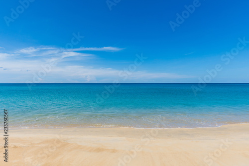 beautiful soft wave on sand at the sea with blue sky sunny day. subject is blurred. © suparat1983