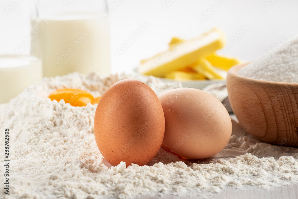 Ingredients for dough and pastry on wooden table, close up on eggs. Ingredients for dough and pastry on wooden table, close up on eggs.