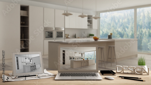 Architect designer desktop concept  laptop and tablet on wooden work desk with screen showing interior design project and CAD sketch  blurred draft in the background  modern white kitchen