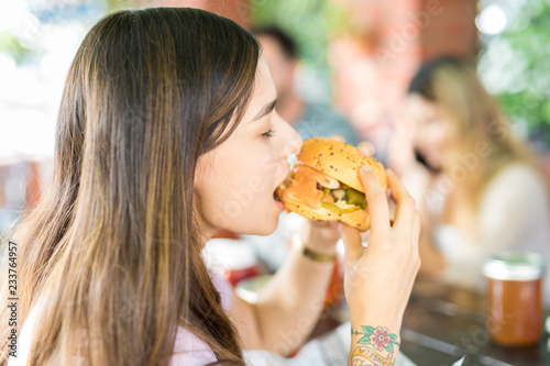 Charming Woman Enjoying Hamburger