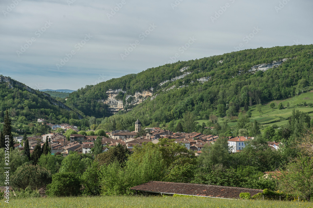 custom made wallpaper toronto digitalView towards ancient town in Ariege, France, with blue sky and mountains in background