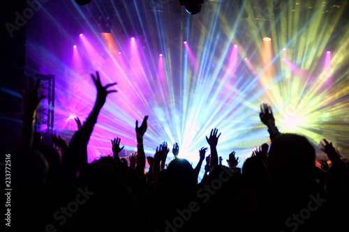 The audience raised hands at a concert in rock club