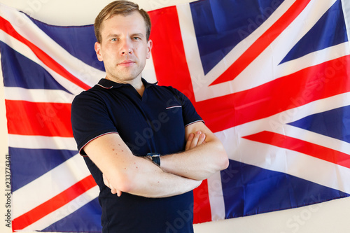 English male student with the British flag at the background English, learn, studying.