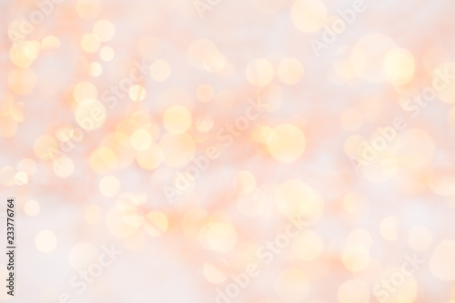 Christmas greeting card. Christmas tree branch on glitter golden bokeh lights background. New Year concept. Copy space.