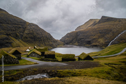 Panorama landscape scenic view of historic traditional houses with grass (turf) roof in village of Saksun, Stroymoy Island. Tourist popular attraction/destination in Faroe Islands (Denmark) 