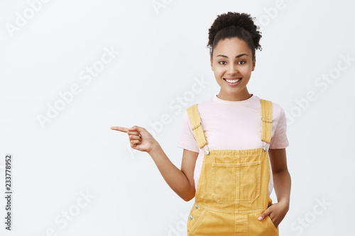 Fotografie Cute girl working part-time at father shop, showing way around
